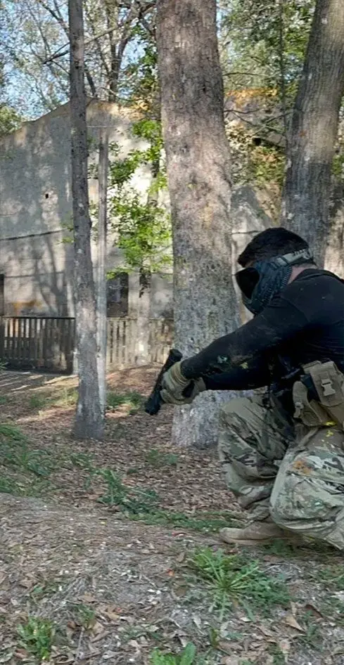 A man with a gun in the forest