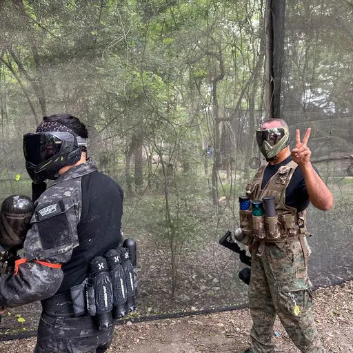 Two customers playing paintball